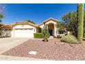 Attractive front exterior showcasing a terracotta tiled roof and low-maintenance desert landscaping at 319 N Riata St, Gilbert, AZ 85234