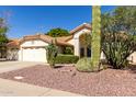 Well-maintained single-Gathering house with mature desert landscaping, a tile roof, and ample parking at 319 N Riata St, Gilbert, AZ 85234