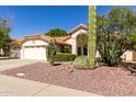 Desirable home with a terracotta roof, low-upkeep desert landscaping, and spacious driveway at 319 N Riata St, Gilbert, AZ 85234