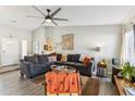 Comfortable living room with a large sectional sofa, hardwood floors, and neutral decor at 3505 S Westfall Ave, Tempe, AZ 85282