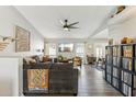 Bright and airy living room featuring hardwood floors, a ceiling fan, and large windows at 3505 S Westfall Ave, Tempe, AZ 85282
