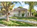 Well-manicured front yard featuring healthy green grass, a lovely walkway, and a charming covered porch at 3534 E Linda Ln, Gilbert, AZ 85234