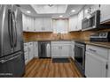 A renovated kitchen featuring stainless steel appliances, white cabinets, and granite countertops at 4225 E Sandia St, Phoenix, AZ 85044