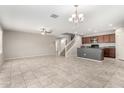 Bright, open-concept living space with tile floors, ceiling fan, and staircase access to the second floor at 5113 E Greenway E St, Mesa, AZ 85205