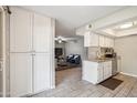 Open kitchen featuring granite countertops and tile flooring, seamlessly connected to the living area at 520 N Stapley Dr # 134, Mesa, AZ 85203