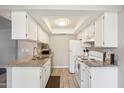 Traditional-style kitchen with tiled floors, white appliances, and ample storage at 520 N Stapley Dr # 134, Mesa, AZ 85203