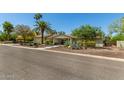 Beautiful single story home with mature trees, desert landscaping, and a peaceful neighborhood street at 6102 E Aster Dr, Scottsdale, AZ 85254
