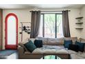 Bright living room featuring a large window, comfortable sofa, and view of the entryway at 620 N 4Th Ave # 10, Phoenix, AZ 85003