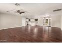 Expansive living room featuring rich wood floors, abundant natural light, and seamless access to the kitchen at 6820 E Pinchot Ave, Scottsdale, AZ 85251