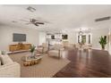 Open-concept living room with hardwood floors, ceiling fan, and comfortable seating at 6820 E Pinchot Ave, Scottsdale, AZ 85251