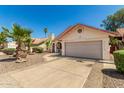 Single-story home featuring a neutral color scheme, two car garage, desert landscaping, and a red tile roof at 7139 W Mcrae Way, Glendale, AZ 85308