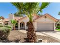 Charming single-story home with well-maintained landscaping, desert rock, mature palm trees, and a tile roof at 7139 W Mcrae Way, Glendale, AZ 85308