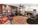Cozy living room with fireplace, built-in bookshelves, and hardwood flooring at 7610 N Via De Manana Dr, Scottsdale, AZ 85258
