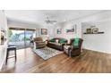 Bright living room boasts hardwood floors, neutral walls, and sliding door to patio at 7610 N Via De Manana Dr, Scottsdale, AZ 85258