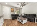 Bright and airy living room showcasing hardwood floors and ample space for relaxing and entertaining at 7858 W Fetlock Trl, Peoria, AZ 85383