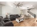Inviting living room featuring a large ceiling fan and hardwood floors for comfort and style at 7858 W Fetlock Trl, Peoria, AZ 85383