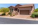 Charming home with a stone facade, well-maintained landscaping, and a spacious driveway leading to a two-car garage at 8304 E Inca St, Mesa, AZ 85207