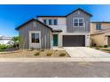 Charming two-story home featuring gray tones, a two-car garage and a welcoming front yard at 9249 E Sector Dr, Mesa, AZ 85212
