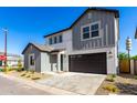 Charming two-story home featuring gray tones, a two-car garage and a welcoming front yard at 9249 E Sector Dr, Mesa, AZ 85212