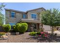Charming stucco two-story home with desert landscaping, a covered porch, and a two-car garage at 9372 W Louise Dr, Peoria, AZ 85383