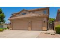 Three-car garage and wide driveway of a two-story home at 986 W Citrus Way, Chandler, AZ 85248