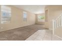Bright living room featuring neutral paint, tile and carpet flooring, and ample natural light at 986 W Citrus Way, Chandler, AZ 85248