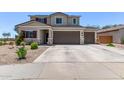 Charming two-story home with a wide driveway, desert landscaping, and a welcoming facade at 997 E White Wing Dr, Casa Grande, AZ 85122