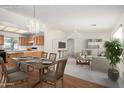 Bright living room boasts an open floor plan, wood floors, and modern decor at 11033 E Keats Ave, Mesa, AZ 85209