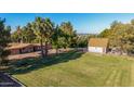 Expansive backyard featuring a large grass area with lush landscaping and a detached garage at 11143 E Vallejo St, Chandler, AZ 85248