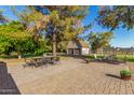 Relaxing brick patio with outdoor furniture and a detached garage at 11143 E Vallejo St, Chandler, AZ 85248