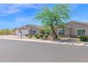 Charming single-story home with a three-car garage and landscaped front yard at 1336 E Belmont Ave, Phoenix, AZ 85020