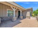 View of the home's covered front porch with brick columns and brick-paved patio at 1336 E Belmont Ave, Phoenix, AZ 85020