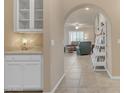 Hallway that offers a view into a living room and a glimpse of the kitchen with tile flooring at 14200 W Village Pkwy # 2128, Litchfield Park, AZ 85340