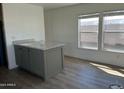 Bright kitchen nook with gray island and large windows allowing for natural light at 1550 W Southern Ave # 20, Phoenix, AZ 85041