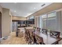 Eat-in kitchen features granite countertops, stainless steel appliances, and a breakfast bar with seating at 17493 W Arroyo Way, Goodyear, AZ 85338