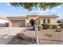 Charming single-story home boasts a well-manicured landscape, a two-car garage, and inviting curb appeal at 19403 E Apricot Ln, Queen Creek, AZ 85142