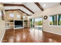 Bright living room with beamed ceilings, fireplace, built-in shelving, and ample natural light at 1943 E Paso Nuevo Dr, Phoenix, AZ 85086