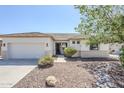 Inviting home exterior with desert landscaping, a covered entryway, and a two-car garage at 2755 N 103Rd Ave, Avondale, AZ 85392