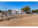 Charming white home with red brick accents and a turquoise front door at 2802 E Virginia Ave, Phoenix, AZ 85008