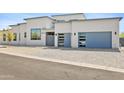 Stylish home with modern garage doors and xeriscaped front yard at 28349 N 113Th St, Scottsdale, AZ 85262