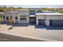 Contemporary home featuring xeriscaped front yard and gray driveway at 28349 N 113Th St, Scottsdale, AZ 85262