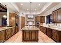 Gourmet kitchen featuring custom wood cabinets, granite countertops, stainless steel appliances, and a center island at 31721 N 138Th Pl, Scottsdale, AZ 85262