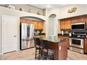 Well-equipped kitchen with stainless steel appliances, granite countertops and a central island at 42076 W Colby Dr, Maricopa, AZ 85138