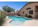 Refreshing private pool with well-kept landscaping, perfect for outdoor relaxation and entertaining at 42076 W Colby Dr, Maricopa, AZ 85138