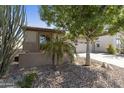 Side view of the home shows charming curb appeal with desert landscaping and a well-manicured yard at 4524 E Narrowleaf Dr, Gilbert, AZ 85298