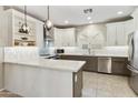 Modern kitchen with stylish white cabinets, stainless steel appliances, and a beautiful backsplash at 4524 E Narrowleaf Dr, Gilbert, AZ 85298