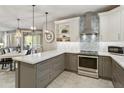 Bright kitchen featuring a center island, gray bottom cabinets, and stainless steel appliances at 4524 E Narrowleaf Dr, Gilbert, AZ 85298