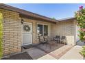 Inviting front porch with brick flooring and comfortable seating area at 6605 W Altadena Ave, Glendale, AZ 85304