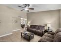 Spacious living room with tile flooring, modern fan and comfortable couches at 6605 W Altadena Ave, Glendale, AZ 85304