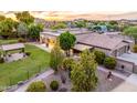 Well-manicured backyard featuring a covered patio, lush lawn, mature trees, and a charming gazebo at 6861 W Calle Lejos --, Peoria, AZ 85383